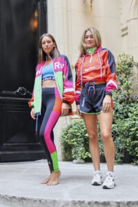 two women dressed in vibrant sports clothes