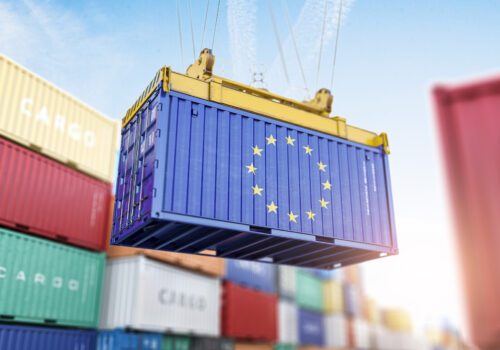 Cargo shipping container with EU European Union flag in a port harbor. Adobe Stock image.