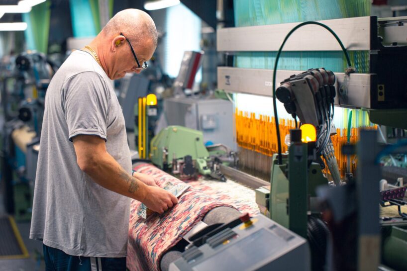 Weaver checking the fabric at David Walters's mill