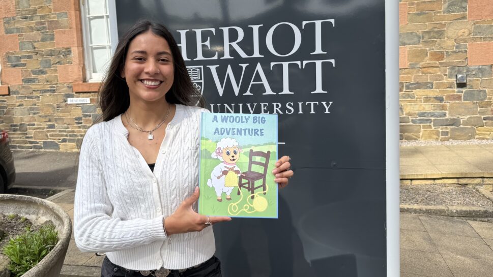 Yennifer Roquett with her children's book about wool