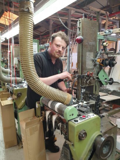 Bowmer Bond trainee sitting at the machine