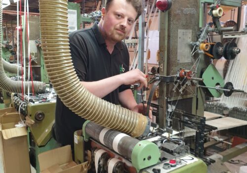 Bowmer Bond trainee sitting at the machine